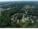 Aerial view of a home nestled amongst trees with neighborhood ammenities nearby at 14010 Promenade Dr, Huntersville, NC 28078