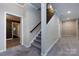 Finished basement with staircase that features a decorative wood accent wall at 14010 Promenade Dr, Huntersville, NC 28078