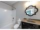 Bathroom with stylish mirror, single sink vanity with great lighting, and shower/tub combo at 14010 Promenade Dr, Huntersville, NC 28078