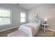 Cozy bedroom with natural light, features a comfortable bed, side table and decor at 14010 Promenade Dr, Huntersville, NC 28078