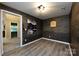 Bonus room featuring dark wood accent walls, recessed lights, and wood flooring at 14010 Promenade Dr, Huntersville, NC 28078