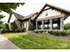 Exterior view of the Olmsted resident clubhouse with stone accents, grass, and landscaping at 14010 Promenade Dr, Huntersville, NC 28078