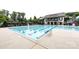 Exterior shot of a community pool with umbrellas and chairs, set up for a day of swimming at 14010 Promenade Dr, Huntersville, NC 28078