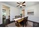 Bright and sunny dining room featuring a modern light fixture and a view into the living room at 14010 Promenade Dr, Huntersville, NC 28078