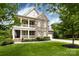 Charming two-story home boasting a stone facade, inviting porch, and well-manicured front lawn at 14010 Promenade Dr, Huntersville, NC 28078