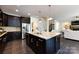 Bright kitchen showcasing a large island, stainless steel appliances, and access to other living spaces at 14010 Promenade Dr, Huntersville, NC 28078