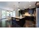 Kitchen with stainless steel appliances, a central island with seating, and dark cabinetry at 14010 Promenade Dr, Huntersville, NC 28078