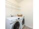 Laundry room features a washer, dryer, and wire shelving for convenient storage at 14010 Promenade Dr, Huntersville, NC 28078