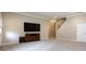 Open living room with neutral walls and trim, recessed lighting, and large entertainment center at 14010 Promenade Dr, Huntersville, NC 28078