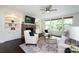 Bright living room featuring built-in shelving, a stone fireplace, and a large window view at 14010 Promenade Dr, Huntersville, NC 28078