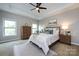 Bedroom boasts tray ceilings, ceiling fan, and large windows for ample natural light at 14010 Promenade Dr, Huntersville, NC 28078
