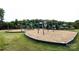 A view of the playground area with play set, swings, and wood chip ground cover at 14010 Promenade Dr, Huntersville, NC 28078