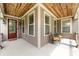 Inviting porch featuring a wood ceiling, seating, and a charming entrance door at 14010 Promenade Dr, Huntersville, NC 28078