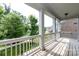 Inviting covered porch with wood decking and white railings, great for relaxing at 14010 Promenade Dr, Huntersville, NC 28078