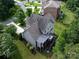 A rear aerial view of this gray home featuring multi-level decks and lush green landscaping at 14010 Promenade Dr, Huntersville, NC 28078