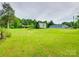 View of the large backyard, with wooden shed, car port structure and the main house at 1406 Old Puckett Pl # 14, York, SC 29745