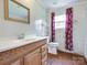 Bathroom with wood-look floors, vanity, and floral curtains at 1406 Old Puckett Pl # 14, York, SC 29745
