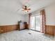 Bedroom with sliding glass door for natural light, ceiling fan, laminate floors, and wood paneling at 1406 Old Puckett Pl # 14, York, SC 29745