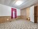 Bedroom featuring paneled walls, tile floors, and an ensuite bathroom at 1406 Old Puckett Pl # 14, York, SC 29745