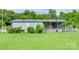 Cozy single-story home featuring a covered porch and convenient ramp access, surrounded by lush greenery and a well-kept lawn at 1406 Old Puckett Pl # 14, York, SC 29745