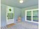 Covered porch featuring a cozy sitting area with a chair and a view through the window at 1406 Old Puckett Pl # 14, York, SC 29745