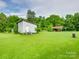 View of large backyard with wooden shed and car port-style structure at 1406 Old Puckett Pl # 14, York, SC 29745