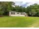 Inviting single Gathering home featuring a manicured lawn surrounded by lush green trees at 159 Blackmon Pond Rd, Lancaster, SC 29720