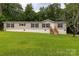 Inviting single Gathering home featuring a manicured lawn with a wooden porch and black shuttered windows at 159 Blackmon Pond Rd, Lancaster, SC 29720