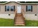 Close up of the wooden porch with stairs leading to the front door of the house at 159 Blackmon Pond Rd, Lancaster, SC 29720