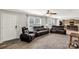 Living room with multiple brown leather couches and large windows with sheer curtains at 159 Blackmon Pond Rd, Lancaster, SC 29720