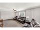 Living room with multiple brown leather couches and large windows overlooking the yard at 159 Blackmon Pond Rd, Lancaster, SC 29720