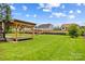 Expansive backyard featuring a wooden pergola, perfect for outdoor entertaining and enjoying the serene surroundings at 159 Forest Abbey Ln, China Grove, NC 28023
