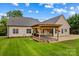 Spacious backyard with a wooden pergola, patio, and a charming fire pit for outdoor gatherings at 159 Forest Abbey Ln, China Grove, NC 28023