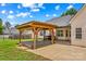 The backyard features an outdoor dining area with a wood pergola and well-kept lawn at 159 Forest Abbey Ln, China Grove, NC 28023