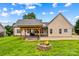 Inviting backyard featuring a pergola-covered deck and a cozy fire pit, perfect for outdoor relaxation at 159 Forest Abbey Ln, China Grove, NC 28023