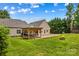Lush backyard showcasing a wooden pergola, patio area, and a cozy fire pit for outdoor enjoyment at 159 Forest Abbey Ln, China Grove, NC 28023