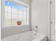 Bright bathroom featuring a window above the bathtub and chrome fixtures at 159 Forest Abbey Ln, China Grove, NC 28023