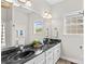Bathroom featuring a double vanity with black countertops and matching mirrors at 159 Forest Abbey Ln, China Grove, NC 28023