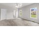 Spacious bedroom with soft carpet, a ceiling fan, and two bright windows at 159 Forest Abbey Ln, China Grove, NC 28023