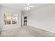 Bright bedroom with neutral walls, soft carpet, a ceiling fan and a view into the kitchen at 159 Forest Abbey Ln, China Grove, NC 28023