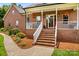 Inviting front porch adorned with festive decor and complemented by well-maintained landscaping at 159 Forest Abbey Ln, China Grove, NC 28023