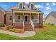 Inviting front porch adorned with festive decor and complemented by well-maintained landscaping at 159 Forest Abbey Ln, China Grove, NC 28023