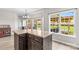 Kitchen featuring a breakfast bar, wood floors, and bright windows overlooking the backyard at 159 Forest Abbey Ln, China Grove, NC 28023