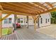 Outdoor back patio with pergola, dining area, and seating, blending indoor-outdoor living at 159 Forest Abbey Ln, China Grove, NC 28023