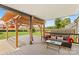 Covered back patio features a wood pergola and comfortable seating area for outdoor living at 159 Forest Abbey Ln, China Grove, NC 28023