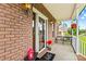 Charming porch with brick accents, seasonal decor, and cozy seating, creating a welcoming entrance at 159 Forest Abbey Ln, China Grove, NC 28023