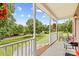 Covered porch featuring decorative columns, hanging planters, and a scenic view at 159 Forest Abbey Ln, China Grove, NC 28023
