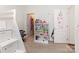 Bright bedroom featuring neutral colors, built in shelving with stairs, and a door to the closet at 1593 Bloomfield Rd, Rock Hill, SC 29732