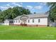 Features a well-maintained lawn, a detached garage and a white house with a gray roof at 1593 Bloomfield Rd, Rock Hill, SC 29732