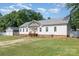 View of the white exterior of the home with a well-manicured lawn and a detached garage at 1593 Bloomfield Rd, Rock Hill, SC 29732